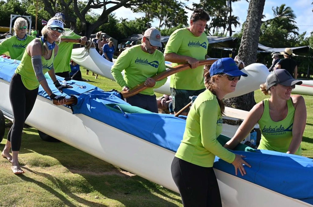 club members bringing a canoe to the water